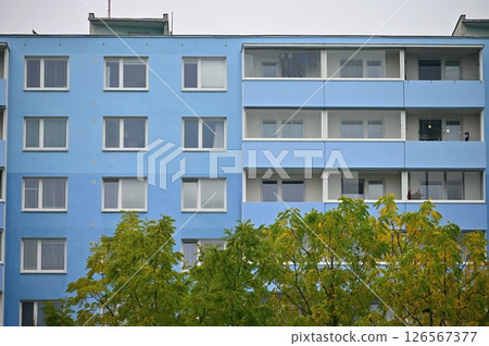 Original prefabricated houses on a housing estate from the communist era in Eastern and Central Europe after reconstruction.. Facade of a modern apartment building with windows and balconies. Czech 126567377