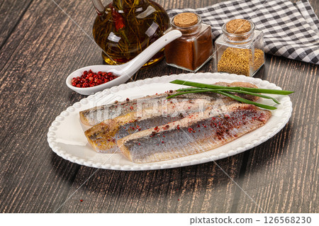 Salted marinated herring fillet with spices Salted marinated herring fillet with spices 126568230