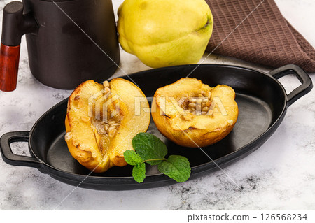 Baked quince with honey and cedar 126568234