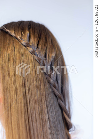 An Elegant Braided Hairstyle that Perfectly Aligns with Modern Fashion Trends and Styles An Elegant Braided Hairstyle that Perfectly Aligns with Modern Fashion Trends and Styles 126568323