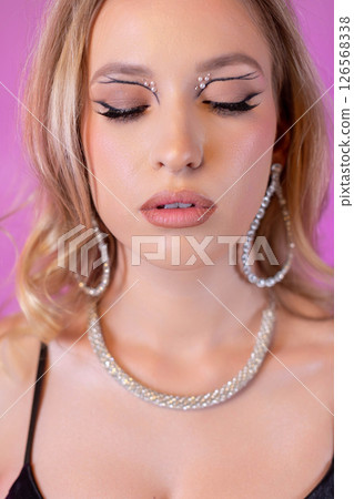 A Stunning Glamorous Beauty Portrait Featuring Sparkling Glitter Makeup and Elegant Jewelry 126568338