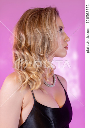 A Glamorous Profile Portrait Set Against a Bright and Colorful Vibrant Pink Background A Glamorous Profile Portrait Set Against a Bright and Colorful Vibrant Pink Background 126568351