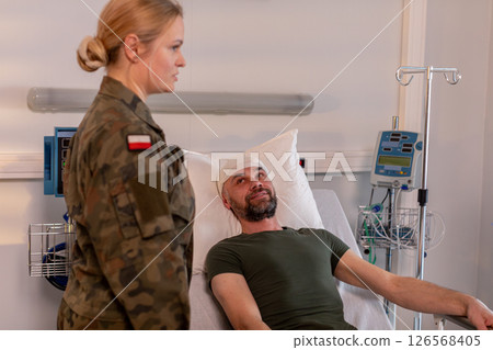 Military Personnel Visiting and Supporting Injured Soldier at the Hospital During Recovery 126568405