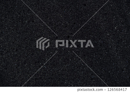 Background of porous foam rubber. Black foam rubber. Packaging material. 126568417