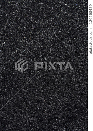 Background of porous foam rubber. Black foam rubber. Packaging material. 126568429