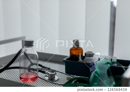 In a laboratory setting, equipment including chemicals and glassware is placed on a table 126568439
