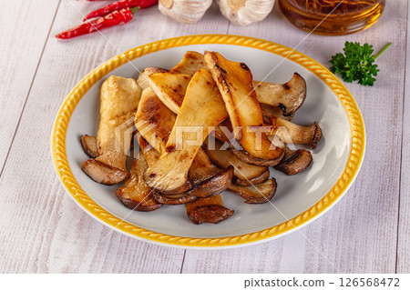 Roasted eringi mushrooms in the plate 126568472
