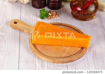 Yellow cheddae cheese over board 126568473