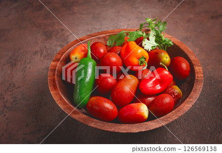 set, cherry tomatoes, with colored peppers, in a wooden bowl, top view, no people, set, cherry tomatoes, with colored peppers, in a wooden bowl, top view, no people, 126569138
