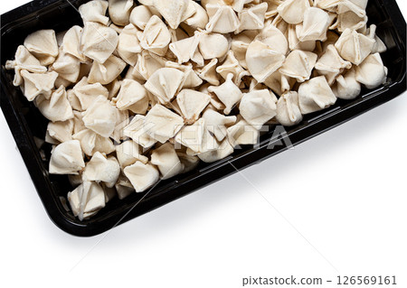 Traditional Turkish dumplings, raw, in a black container, white background, isolate, top view, no people, 126569161