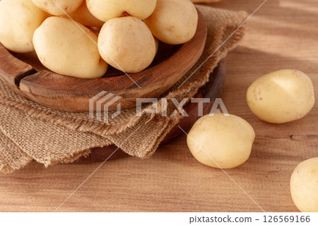 boiled new potatoes, in a wooden bowl, on a rustic table, natural light, no people, 126569166