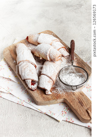 bagels with filling, sweet pastries, sprinkled with powdered sugar, on a wooden board, dessert, breakfast, bagels with filling, sweet pastries, sprinkled with powdered sugar, on a wooden board, dessert, breakfast, 126569173