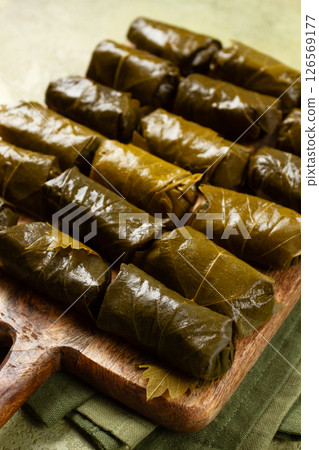 dolma, minced meat with rice, in grape leaves, minced meat rolls, on a chopping board, top view, no people, 126569177