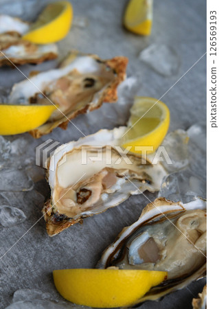 open oysters and lemons on the table open oysters and lemons on the table 126569193
