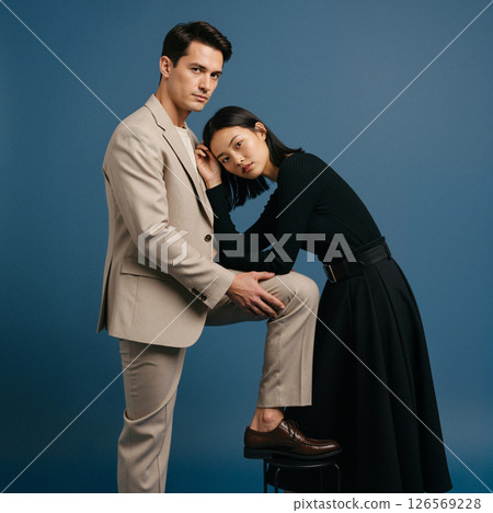 Couple Posing Beige Suit Black Dress Couple Posing Beige Suit Black Dress 126569228