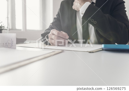 Financial advisor working at his desk Financial advisor working at his desk 126569275
