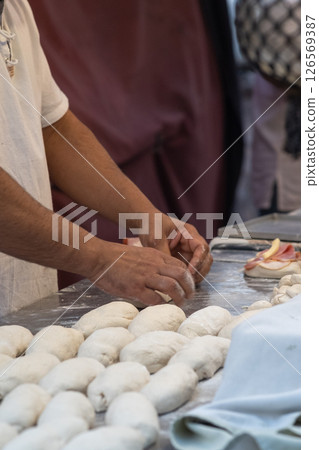 A man's hands working with the dough 126569387