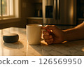 Hand Holding Mug at Sunrise 126569950