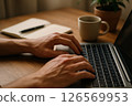 Hands Typing on Laptop 126569953