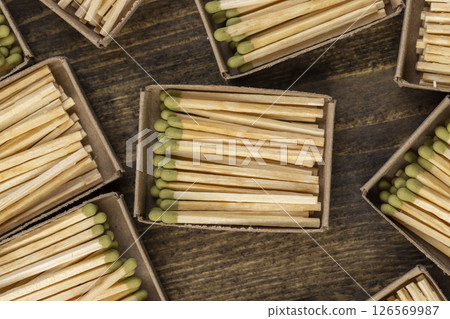 wooden matches with green grey poured into cardboard boxes , the green head of a wooden match laid out in cardboard boxes wooden matches with green grey poured into cardboard boxes , the green head of a wooden match laid out in cardboard boxes 126569987