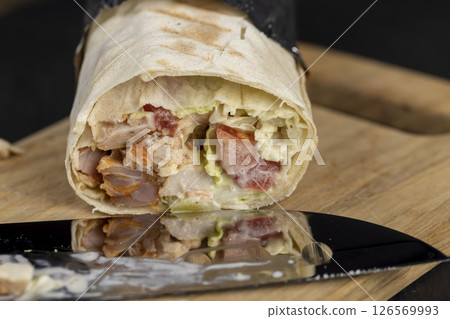 fast food shawarma made from various ingredients packed in foil fast food shawarma made from various ingredients packed in foil 126569993