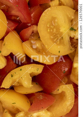 red and yellow tomatoes during salad preparation, preparation of salad from sliced tomatoes with oil red and yellow tomatoes during salad preparation, preparation of salad from sliced tomatoes with oil 126570001