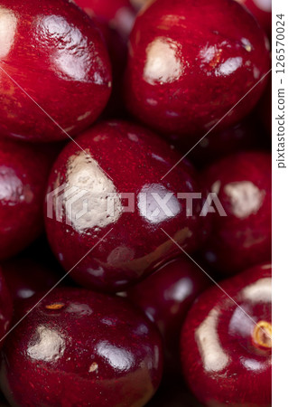 ripe red cherry berries , red cherry fruits on the kitchen table closeup 126570024