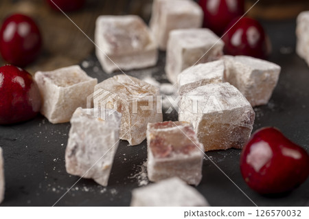 cubes of Turkish delight with the addition of berries in powdered sugar 126570032