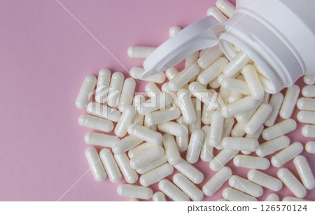 Much medical pills and drugs in white package on the pink background. Healthcare concept. Space for text. 126570124