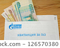 everal bills (Russian rubles) stick out of the Gazprom gas bill for the apartment 126570380