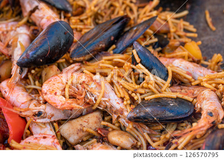 street food - pasta and seafood shrimp and shells on the french riviera 126570795