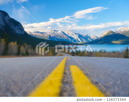 Asphalt road. High mountains on the horizon. The direction of travel. Asphalt road. High mountains on the horizon. The direction of travel. 126571564