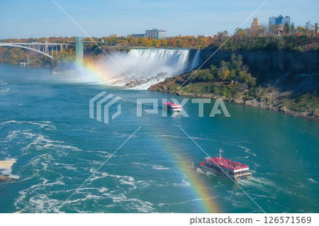 Niagara Falls. A pleasure boat with people near the huge famous waterfall. Niagara Falls. A pleasure boat with people near the huge famous waterfall. 126571569