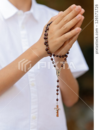 Child hands holding bible, serving God, praying hands, home church community 126571726
