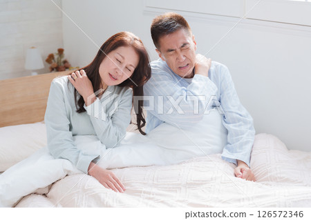 Senior couple with stiff shoulders Senior couple with stiff shoulders 126572346