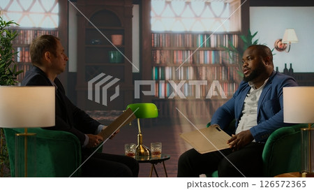 African american secret agent destroying important state secrets, tearing confidential documents to clear potential incriminating evidence. Diverse CIA staff working in the underworld. Camera A. African american secret agent destroying important state secrets, tearing confidential documents to clear potential incriminating evidence. Diverse CIA staff working in the underworld. Camera A. 126572365