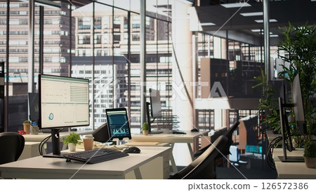 Empty modern workspace with advanced technology to enhance efficiency and productivity, helping business professionals focus on financial strategies. Global enterprise success objectives. 126572386
