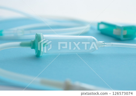 Close-up of an IV tube immediately after opening, with a blue background 126573074
