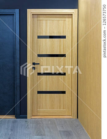 Wooden beige closed door 126573750