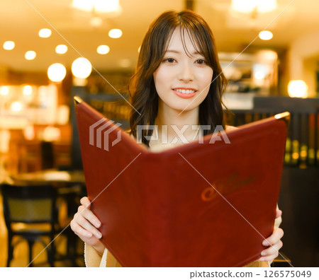 Woman holding a menu book 126575049