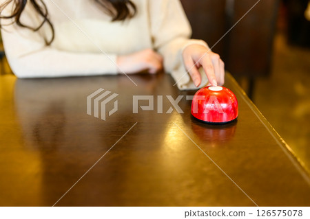 Woman's hand pressing the call bell Woman's hand pressing the call bell 126575078