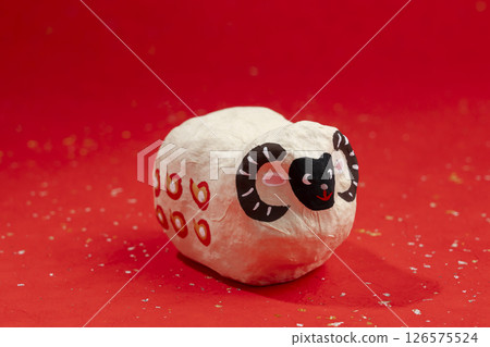 Japanese paper zodiac doll (year of the sheep) red background 126575524