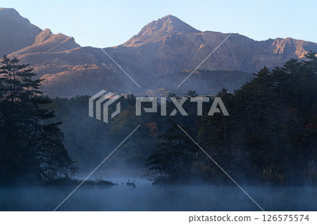 Mount Bandai in the morning glow and Lake Goshiki shrouded in morning mist 126575574