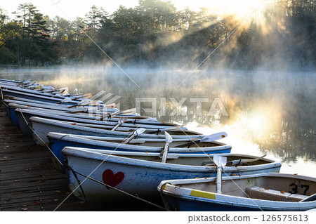 Lake Goshiki-numa, shrouded in morning mist and the morning sun shining through 126575613