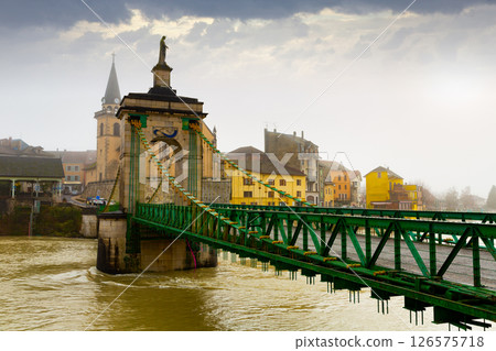 View of Seyssel on Rhone river with Saint-Blaise church and suspension bridge in winter View of Seyssel on Rhone river with Saint-Blaise church and suspension bridge in winter 126575718