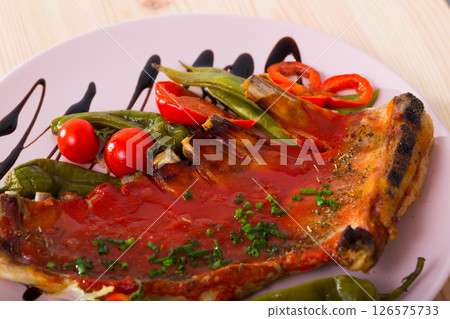 Mutton ribs baked under hot tomato sauce 126575733
