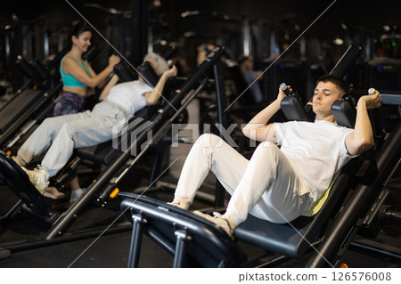 Guy uses hack squat machine to strengthen muscles 126576008