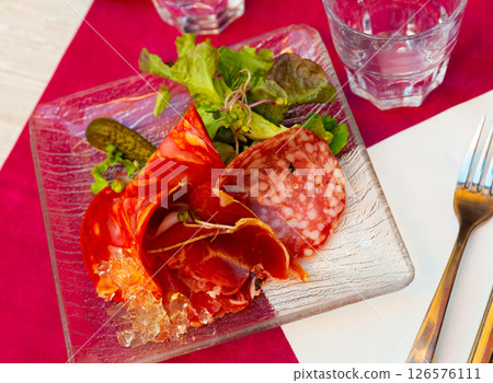 French dish - cold cuts with lettuce and pickled cucumbers clodeup 126576111