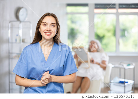 Portrait of young female doctor in scrub. Portrait of young female doctor in scrub. 126576115
