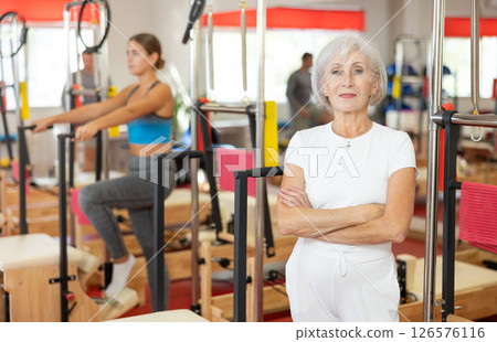 Elderly woman posing in pilates studio Elderly woman posing in pilates studio 126576116